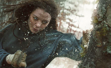 HD desktop wallpaper featuring Esme Creed-Miles as Hanna in action, with a dynamic, snowy backdrop.