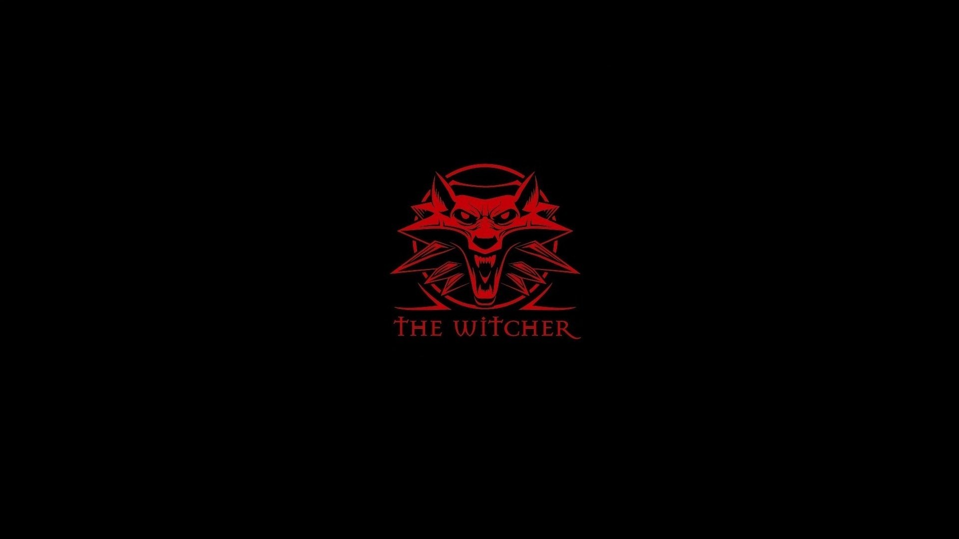 HD PC desktop wallpaper featuring a red stylized wolf emblem and The Witcher text from the video game against a black background.