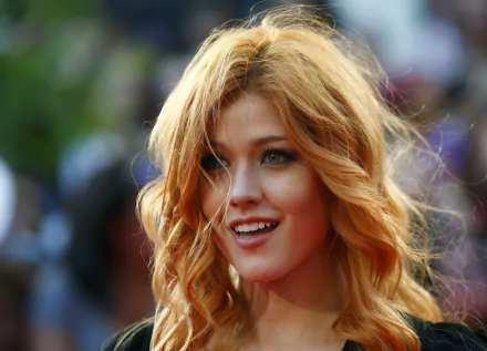 Close-up of American actress Katherine McNamara smiling with red hair, captured in sharp focus against a blurred background in 4K Ultra HD quality.
