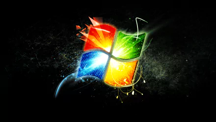 HD PC desktop wallpaper showing a glowing, stylized Windows 7 logo with blue, red, green, yellow light bursts on a dark, textured technology background.