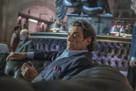 HD desktop wallpaper featuring Ian McShane in a scene from the movie John Wick: Chapter 3 - Parabellum, portraying a contemplative moment in a dimly lit setting.