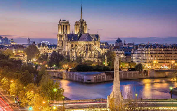 HD desktop wallpaper showcasing the iconic Notre-Dame de Paris cathedral at dusk, highlighting its Gothic architecture and the surrounding Paris cityscape.