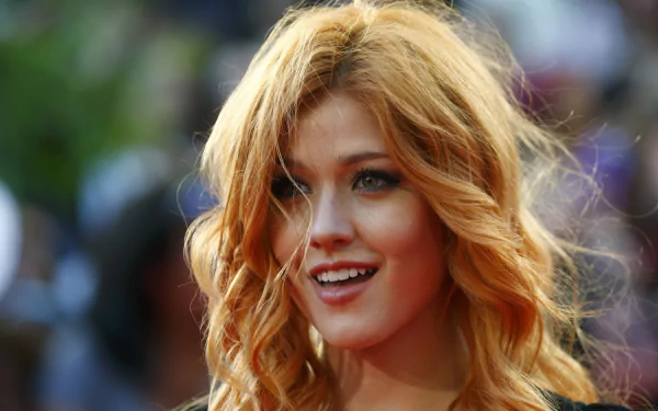 Close-up of American actress Katherine McNamara smiling with red hair, captured in sharp focus against a blurred background in 4K Ultra HD quality.