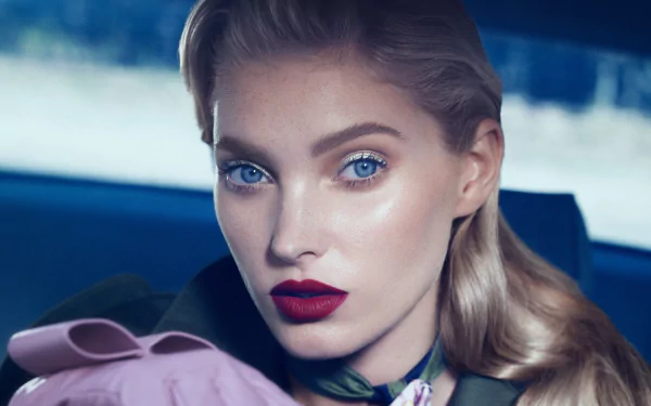 Close-up portrait of Swedish model and celebrity Elsa Hosk with blonde hair, striking blue eyes, and bold lipstick, captured in 4K Ultra HD.