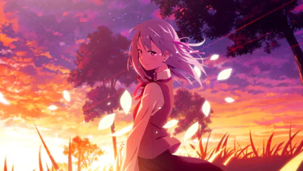 Anime-style HD desktop wallpaper of a girl standing by a tree during a vibrant sunset with glowing petals gently falling around her.