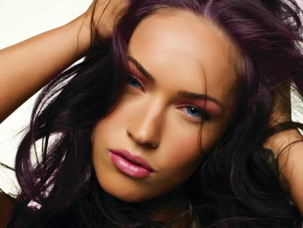 HD desktop wallpaper featuring celebrity Megan Fox with striking purple hair and captivating blue eyes, exuding confidence and allure.