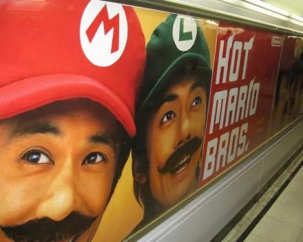 Advertisement featuring realistic portraits of Mario and Luigi from the Super Mario video game, displayed as an HD PC desktop wallpaper and background.
