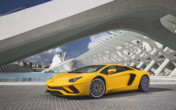 Yellow Lamborghini Aventador S supercar parked in front of a modern architectural structure, showcased in stunning 4K Ultra HD for PC desktop wallpaper and background.