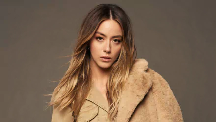 Portrait of American actress and celebrity Chloe Bennet in a tan fur coat, captured in a 4K Ultra HD PC desktop wallpaper and background.