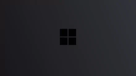 4K Ultra HD Microsoft Windows desktop wallpaper featuring a sleek, minimalistic design with a dark background and the black Windows logo centered.