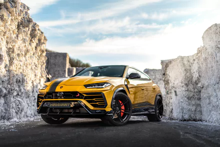 A yellow Lamborghini Urus SUV parked between rugged white rock formations, captured in ultra HD with a bright sky backdrop.