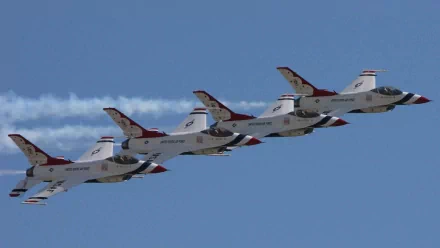 A stunning HD wallpaper featuring a formation of F-16 fighter jets performing a stunt, showcasing military precision against a clear blue sky.