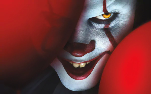 Close-up of Pennywise the clown from It Chapter Two, with glowing eyes and red balloons, rendered in 4K Ultra HD for PC desktop wallpaper.