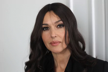 Close-up portrait of a woman with long black hair and brown eyes, subtle makeup and a calm expression against a neutral background, 2K Quad HD PC desktop wallpaper.