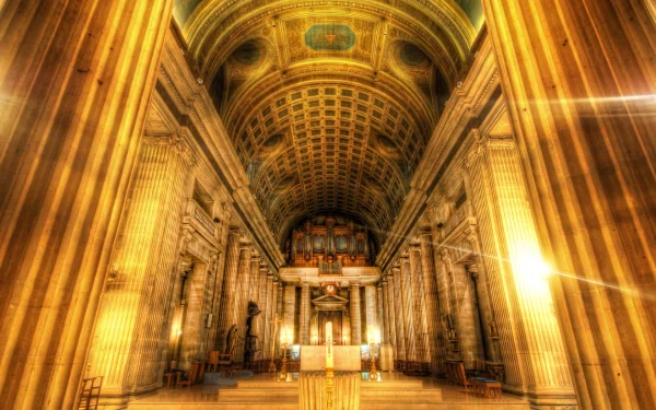 HD PC desktop wallpaper showcasing the glowing interior of Sacré-Cœur, highlighting its grand columns and ornate religious architecture.