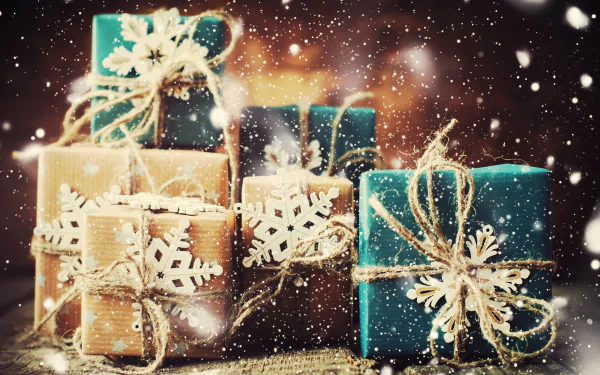 Misc, gift — 4K Ultra HD PC desktop wallpaper of teal and kraft-wrapped presents with twine and snowflake tags, falling snow and warm bokeh lights in the background.
