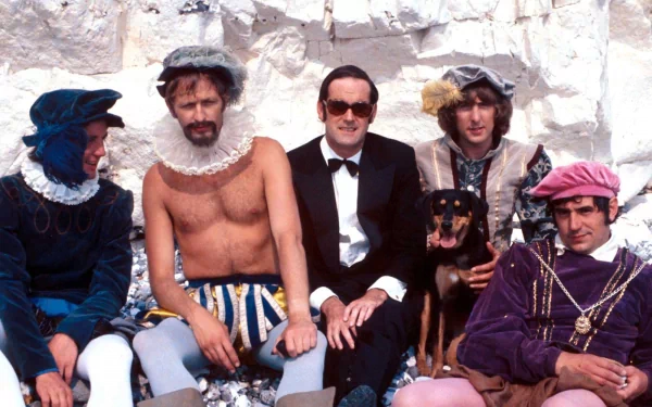 Five characters from *Monty Python's Flying Circus* pose playfully against a rocky backdrop, showcasing the show's iconic humor and distinctive style in this HD desktop wallpaper.