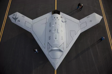 Top-down view of Northrop Grumman X-47B stealth military UAV on tarmac — 2K Quad HD PC desktop wallpaper and background.