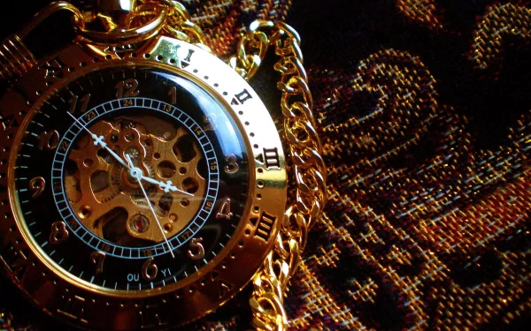 HD desktop wallpaper featuring a close-up of an intricate golden steampunk pocket watch with a visible gear mechanism, set against a richly patterned fabric background. Sci-fi and steampunk elements.