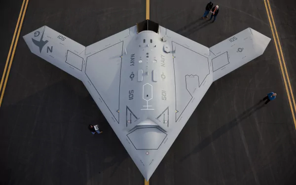 Top-down view of Northrop Grumman X-47B stealth military UAV on tarmac — 2K Quad HD PC desktop wallpaper and background.