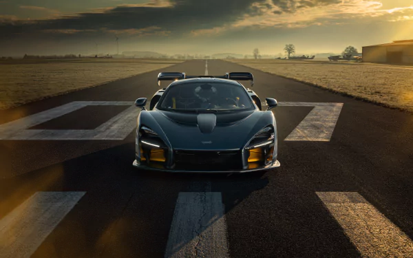 A sleek McLaren Senna supercar captured in stunning 8K Ultra HD, positioned on a runway at sunset, showcasing its aggressive design and aerodynamic features.