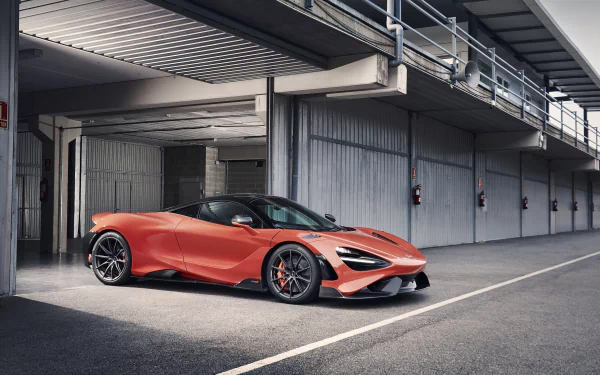 Orange McLaren 765LT supercar parked in a modern concrete pit lane garage, presented as a high-resolution 4K Ultra HD PC desktop wallpaper.