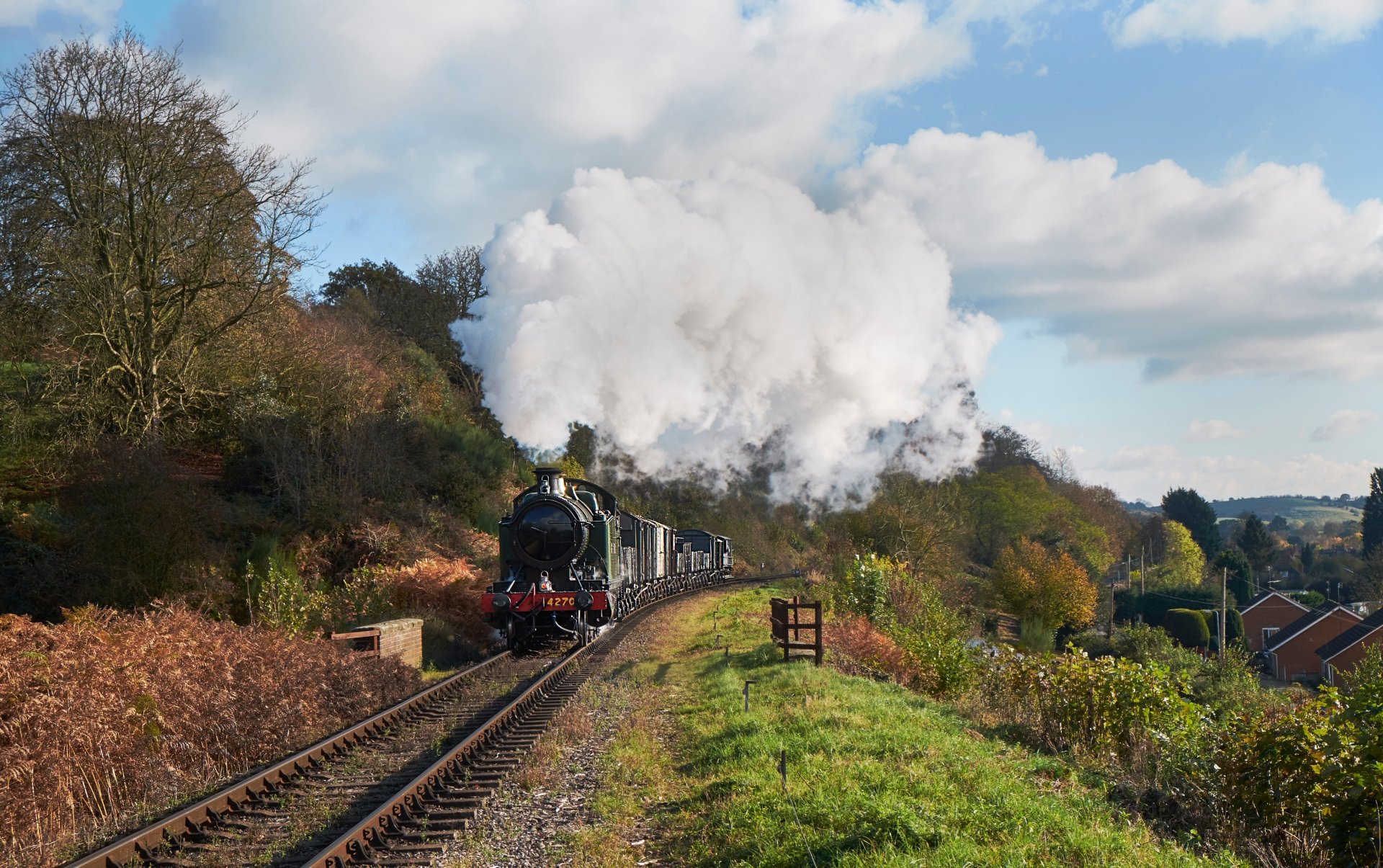 4K Ultra HD PC desktop wallpaper and background showing a vehicle: a vintage steam locomotive steaming along rural tracks, billowing white smoke against blue sky and green countryside.