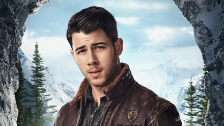 HD desktop wallpaper of Nick Jonas from the movie Jumanji: The Next Level, set against a mountain landscape with pine trees and a cloudy sky.