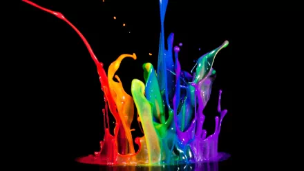 A vivid splash of colorful paint against a black background, showcasing a dynamic blend of artistic hues. This HD PC desktop wallpaper brings vibrant energy to any screen.