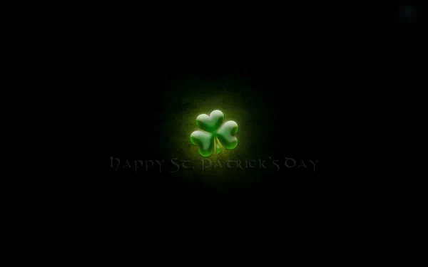 HD PC desktop wallpaper featuring a glowing green shamrock symbol celebrating the St. Patrick's Day holiday against a dark background.