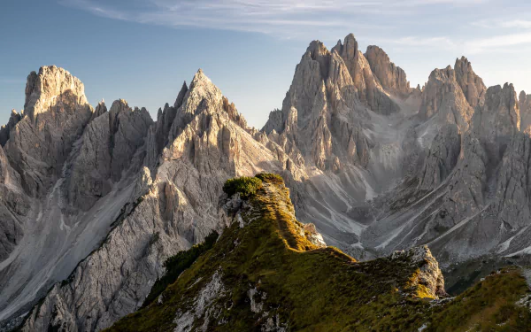 4K Ultra HD desktop wallpaper showcasing the rugged Dolomites mountain range bathed in soft natural light, highlighting the dramatic peaks and serene alpine landscape.