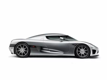 A sleek silver Koenigsegg CCX vehicle displayed in profile, showcasing its aerodynamic design and high-performance wheels, set against a clean background, designed for high-definition screens.