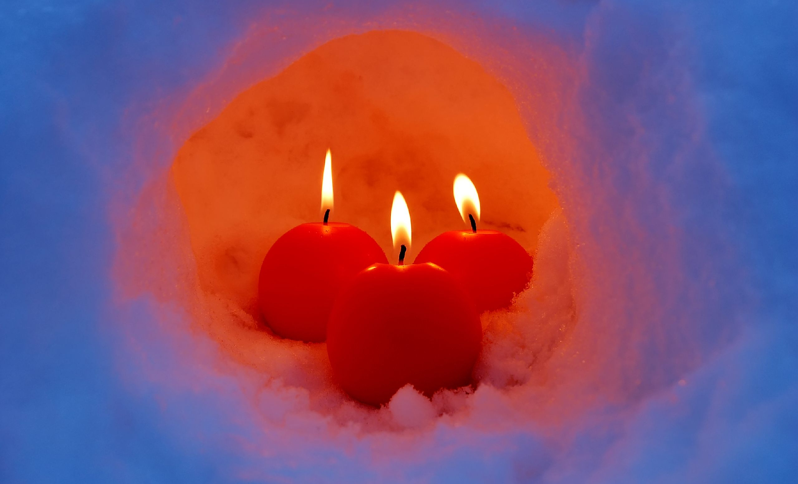 Winter-themed candle with snow in the background. Perfect for desktop wallpaper.
