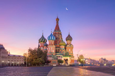Saint Basil's Cathedral in Moscow, Russia, showcasing its colorful domes under a crescent moon at sunset, captured in stunning 4K Ultra HD quality.