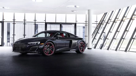 Black Audi R8 RWD coupe with red-accent wheels in a bright modern showroom, 4K Ultra HD PC desktop wallpaper background