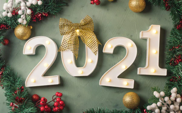 Holiday New Year 2021 HD PC desktop wallpaper and background — lit 2021 numerals with a gold bow, evergreen garland, red berries and gold ornaments on a green backdrop.