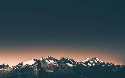 4K Ultra HD desktop wallpaper featuring a mountain range silhouetted against a soft, warm sunset sky in nature.