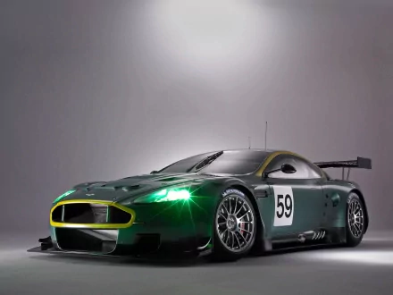Aston Martin DBR9 in a striking grey and green design, showcasing its sporty features. A dynamic HD desktop wallpaper highlighting this iconic sports car.