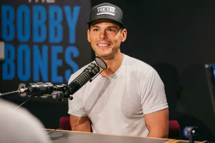 HD desktop wallpaper featuring a smiling person wearing a cap, sitting in front of a microphone with BOBBY BONES in the background.