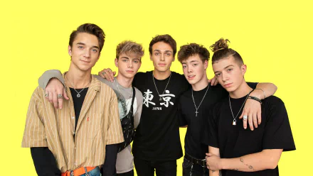 HD desktop wallpaper featuring the band Why Don't We, with members posing against a bright yellow background.