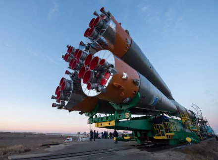 HD desktop wallpaper featuring the Soyuz rocket on a transport vehicle against a twilight sky.