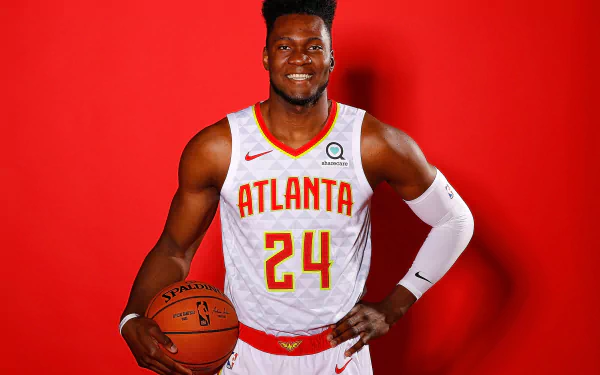 HD wallpaper of basketball player in Atlanta jersey number 24, posing with a ball against a red background.