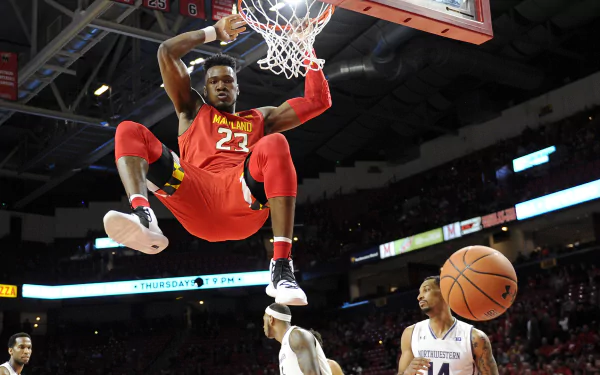HD desktop wallpaper featuring Bruno Fernando mid-dunk in a basketball game, with the ball bouncing off the rim.