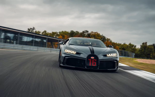 Front view of a black Bugatti Chiron Pur Sport supercar speeding on a racetrack, captured in stunning 8K Ultra HD for a PC desktop wallpaper background.