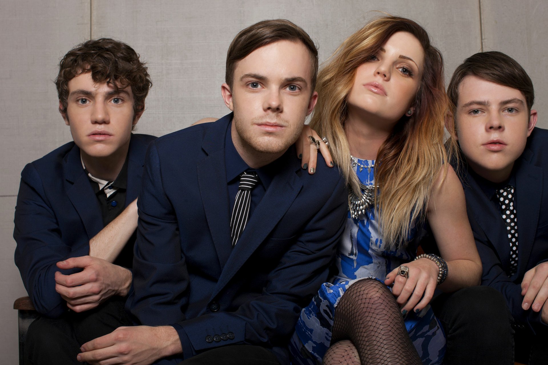 HD desktop wallpaper of Echosmith with Sydney Sierota posing with band members in formal attire.