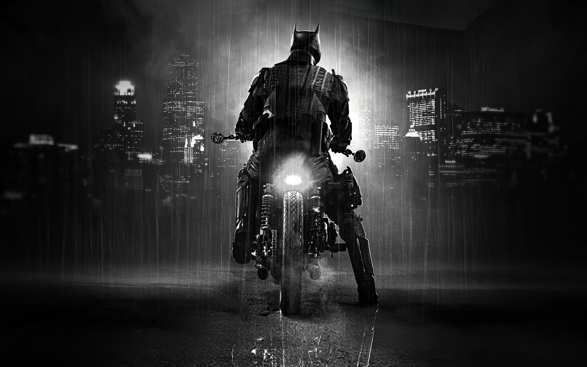 HD desktop wallpaper featuring Batman from the movie The Batman, shown riding a motorcycle against a rainy, dark cityscape backdrop.