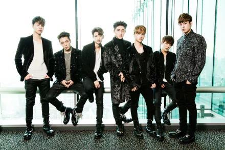 HD desktop wallpaper featuring the group iKON in stylish outfits, standing together against a glass backdrop with a city view.