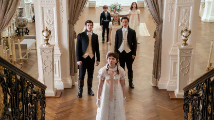 HD desktop wallpaper featuring characters from Bridgerton in elegant period costumes inside a grand room with ornate decor.