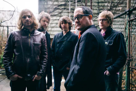 HD desktop wallpaper featuring the band The Hold Steady posing thoughtfully in an urban outdoor setting.