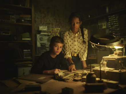HD desktop wallpaper from Secrets of Sulphur Springs featuring two characters examining clues in a dimly lit room.